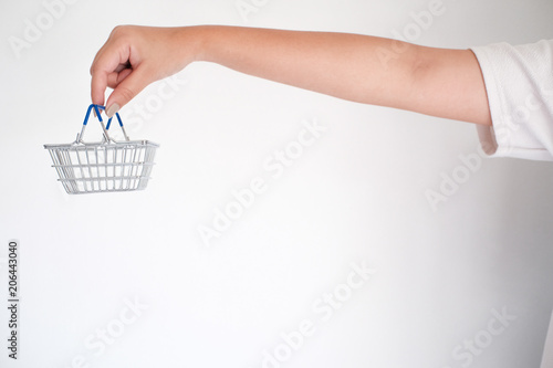 Woman hand forefinger pushing small shopping cart with Internet online shopping concept.