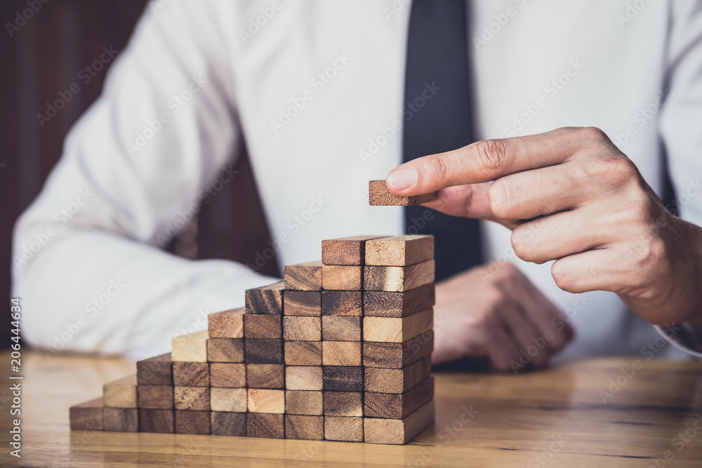 Risk To Make Business Growth Concept With Wooden Blocks, hand of man has piling up and stacking a wooden block, Alternative risk concept, plan and strategy in business Risk To Make Business Growth Concept With Wooden Blocks, hand of man has piling up and stacking a wooden block, Alternative risk concept, plan and strategy in business
