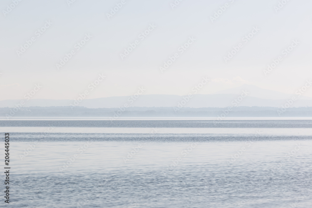 Minimalist, graphic view of a lake, with stripes of different sh