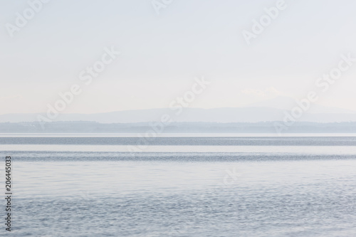 Minimalist, graphic view of a lake, with stripes of different sh