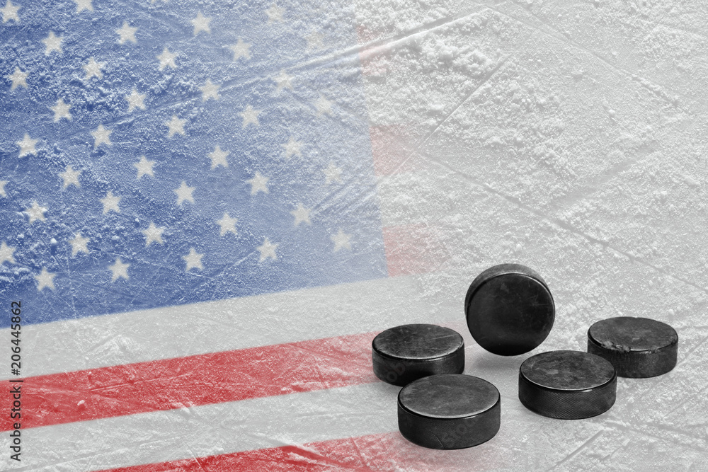 Naklejka premium Image of the American flag on ice and hockey pucks