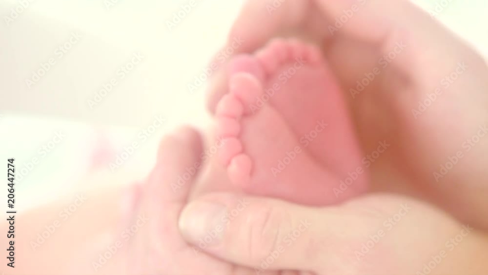 Tiny newborn baby's feet in female hands closeup. Baby feet in mother hands. Happy family concept. Slow motion. 3840X2160 4K UHD video footage Tiny newborn baby's feet in female hands closeup. Baby feet in mother hands. Happy family concept. Slow motion. 3840X2160 4K UHD video footage