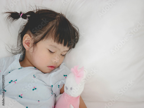 Asian little  girl sleeping in the bedroom.