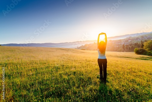 Obraz na płótnie Woman enjoying beautiful sunrise at mountains. w salonie
