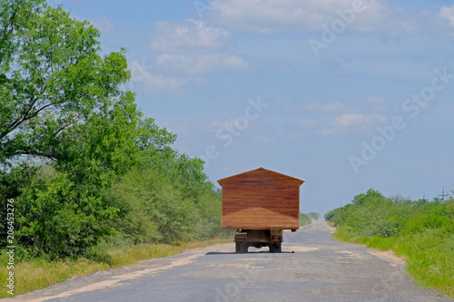 Prefab house moving on a truck and looking like a motorhome rv, Gran Chaco, Paraguay, South America photo