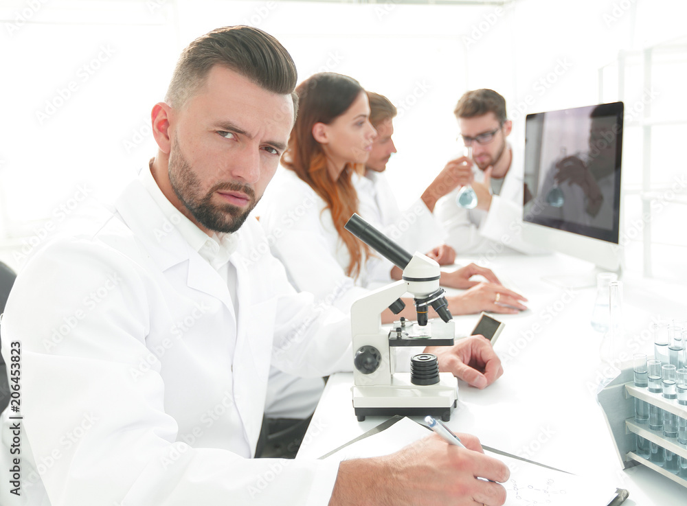 serious scientists working in the laboratory serious scientists working in the laboratory