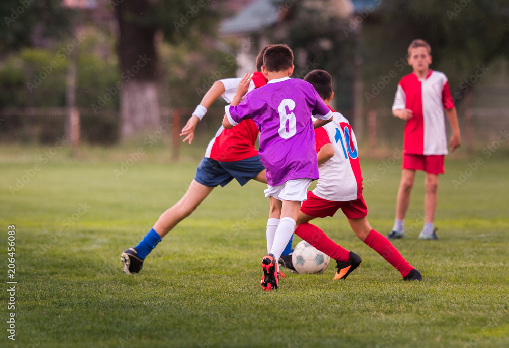 Obraz premium Young children players football match on soccer field