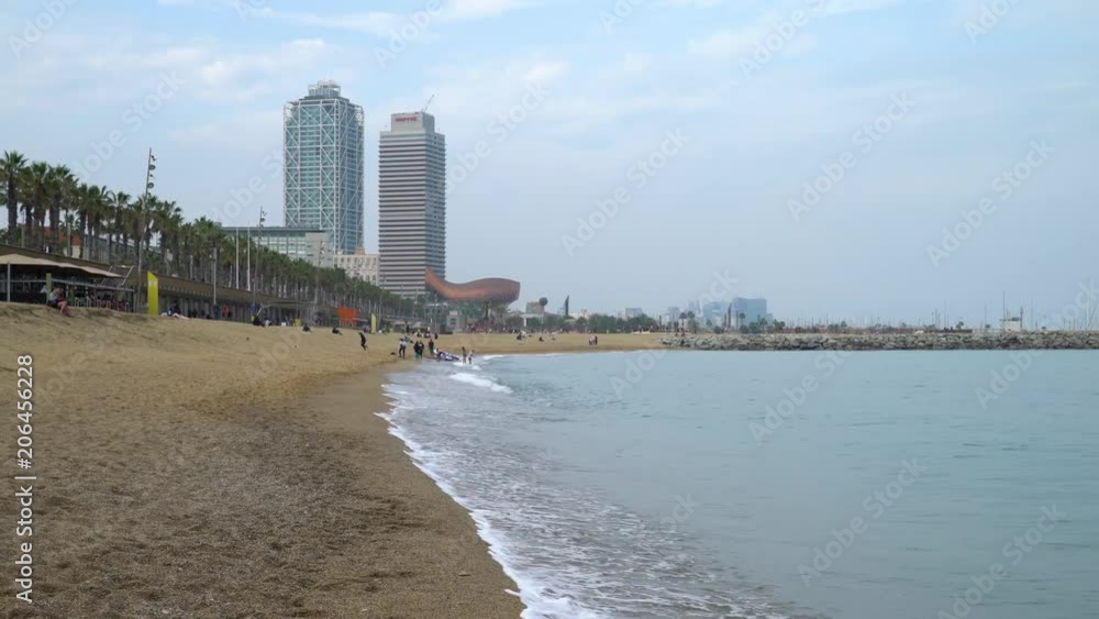 Barcelona, Spain. Walk along the seashore at Barceloneta beach in the evening Barcelona, Spain. Walk along the seashore at Barceloneta beach in the evening