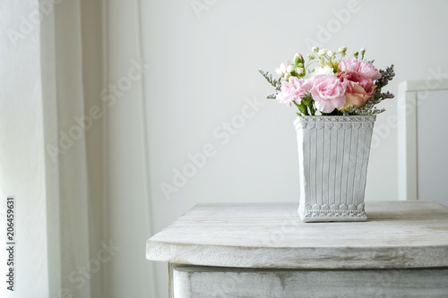 Carnation flower in cement pot on vintage cabinet at the bedroom