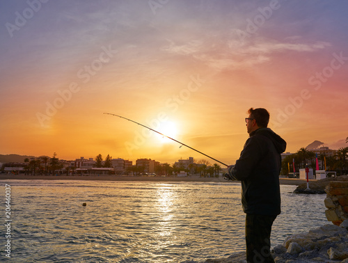 Angler with spinning rod fishing in Mediterranean