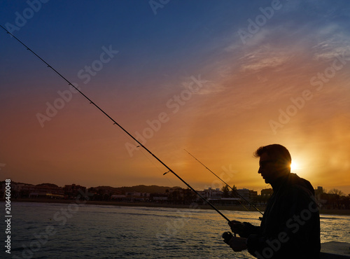 Angler with spinning rod fishing in Mediterranean
