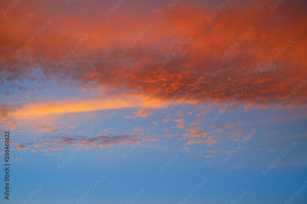 Sunset sky with orange clouds and blue