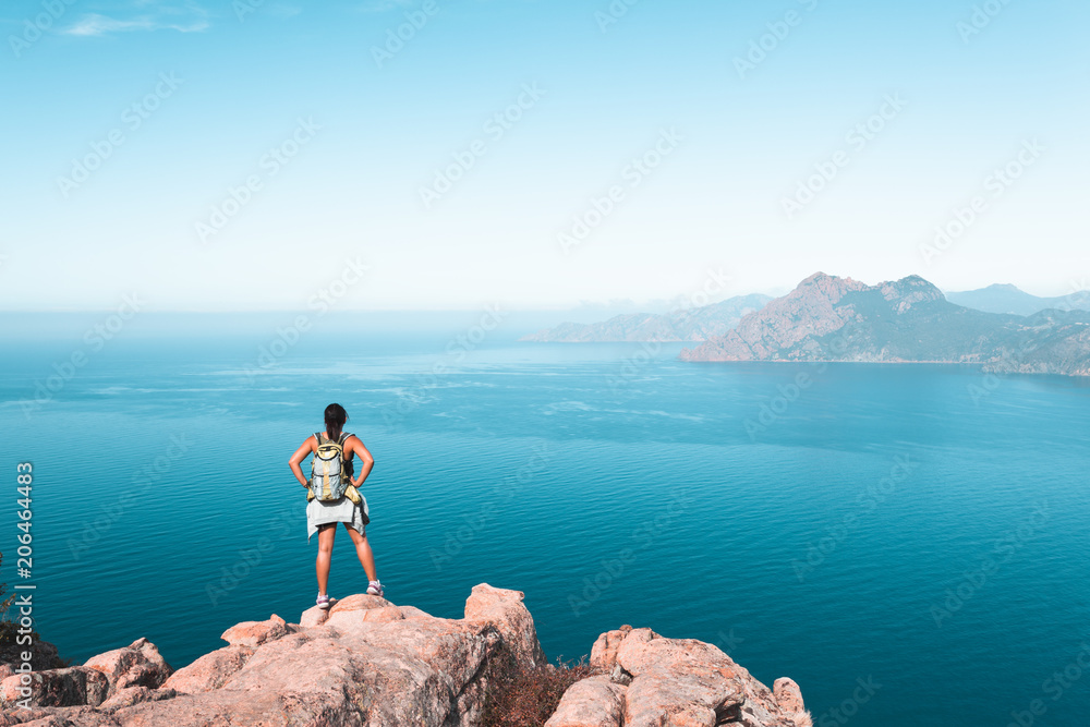 Hiker looking at the view at Calanques de Piana in Corsica, France