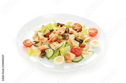 warm salad sea breeze with tomato cherry squid mussels roasted salmon quail eggs on a white background
