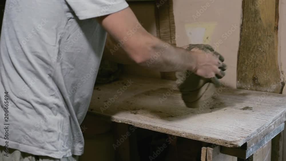 Closeup potter knead clay on desk, prepared for works Closeup potter knead clay on desk, prepared for works
