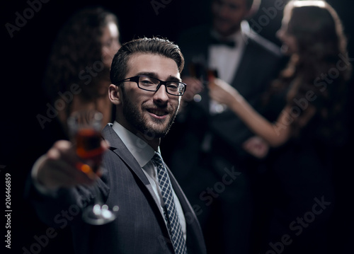 elegant man raising his glass with the toast