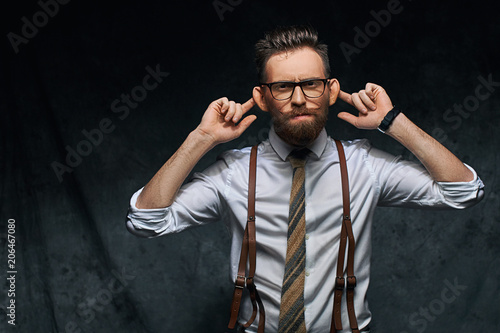 Photography Young stylish hipster businessman or manager is stretching his ears, imitating m