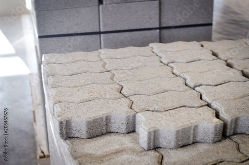 Motion blur image of cement building blocks stacked piled in warehouse background, closeup fabric plant manufacture grey textured abstract surface