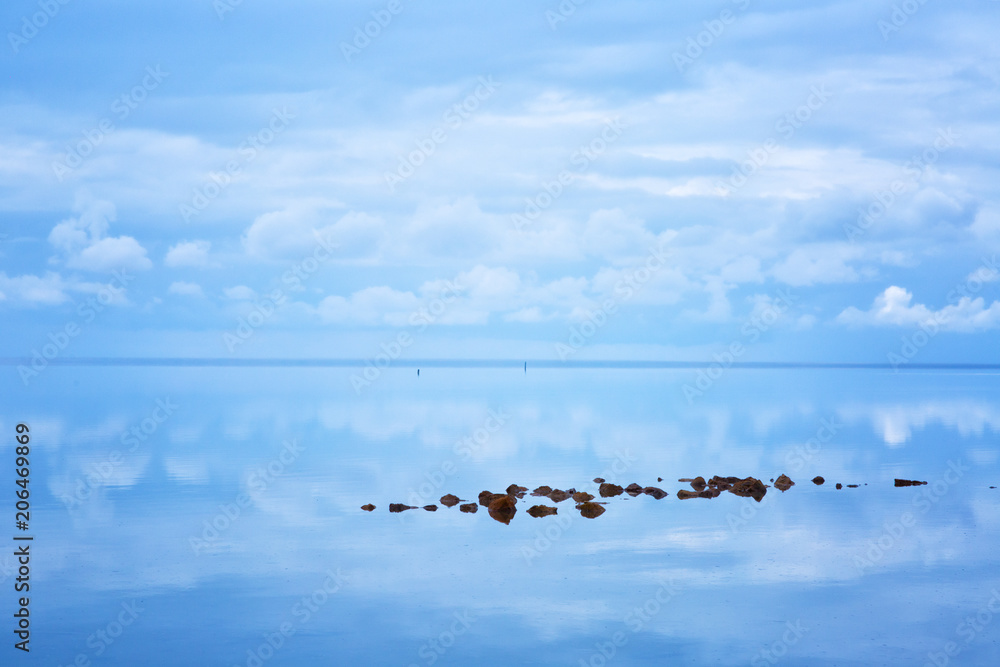 Stones and reflection of sky in lake Elton, Russia Stones and reflection of sky in lake Elton, Russia