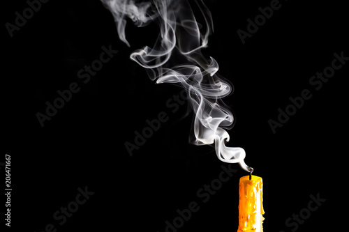 Yellow Candle with white smoke on black background