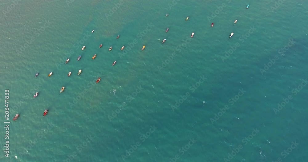 Aerial view of traditional fishing boat moored in the turquoise sea of Rio do Fogo, Brazil. Aerial view of traditional fishing boat moored in the turquoise sea of Rio do Fogo, Brazil.