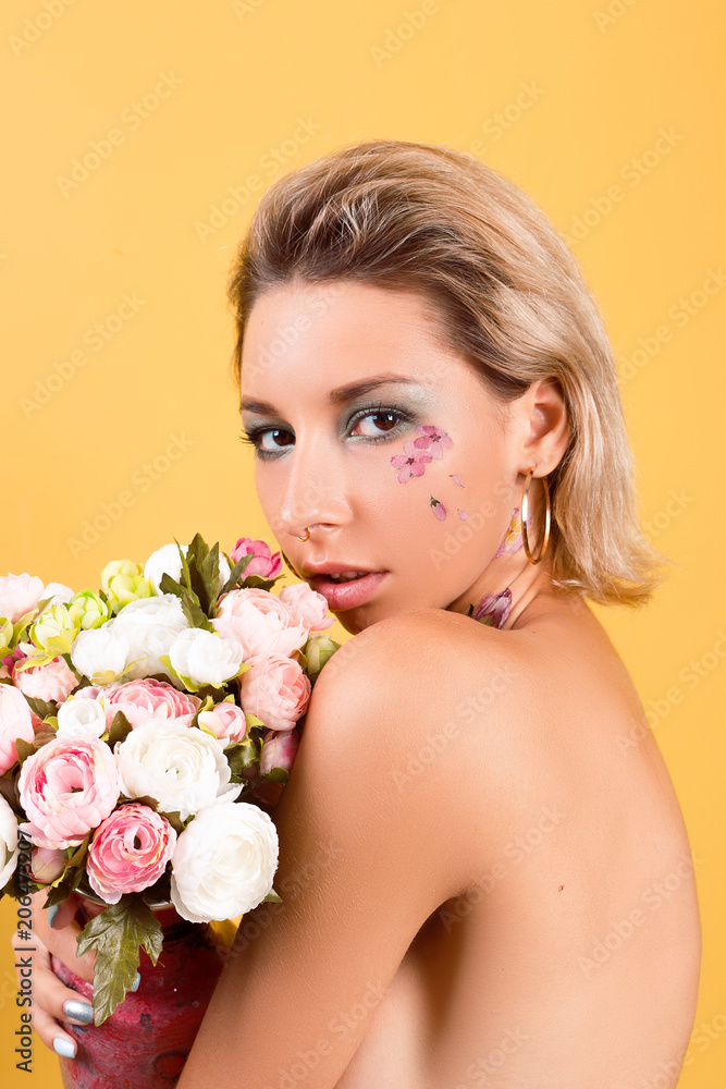 Portrait of a beautiful girl with clean skin in flowers