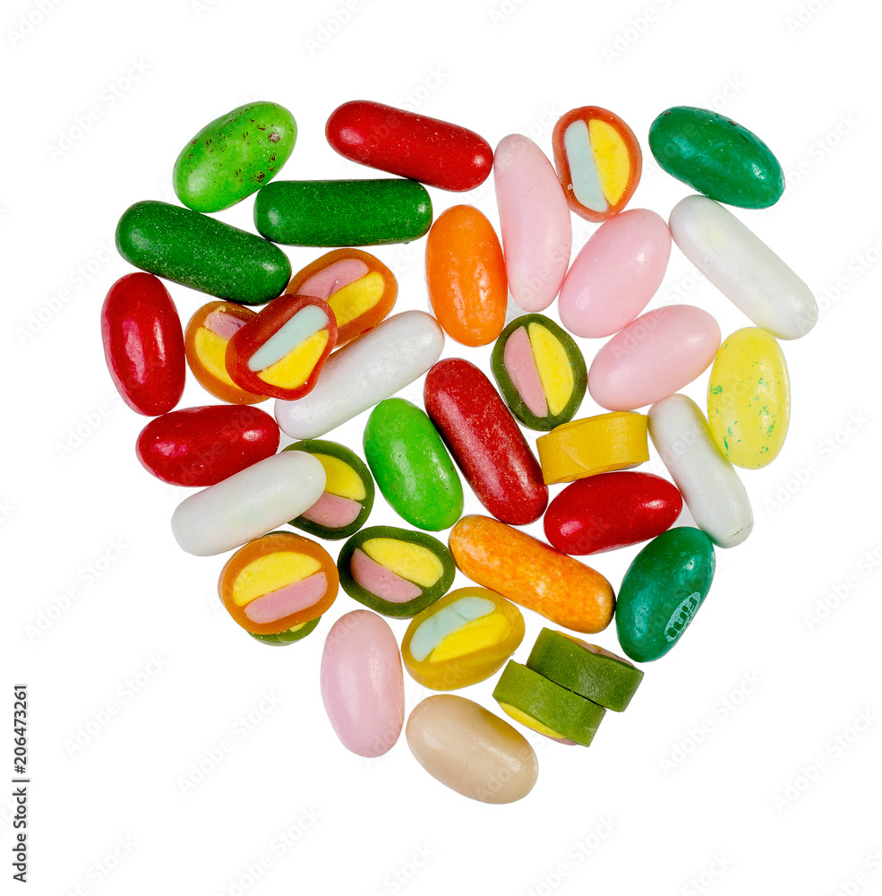Sweets, sweet bright colored caramel, in the shape of heart, on a white background Sweets, sweet bright colored caramel, in the shape of heart, on a white background