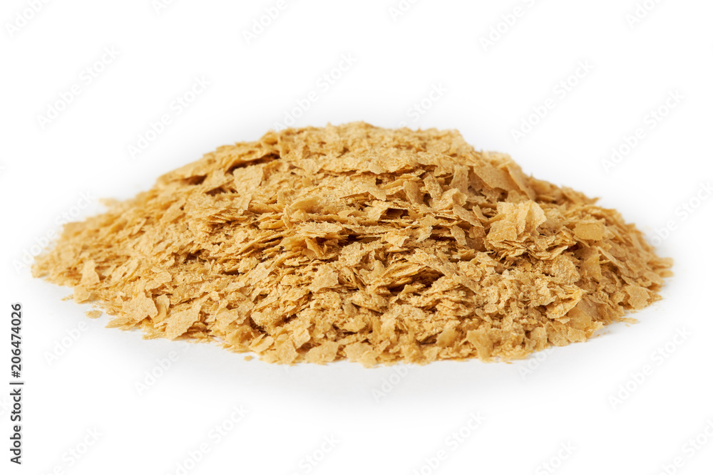 Nutritional brewers yeast flakes isolated on white background Nutritional brewers yeast flakes isolated on white background