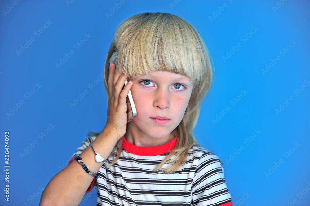 Portrait of blonde long hair boy talking by mobile phone Portrait of blonde long hair boy talking by mobile phone