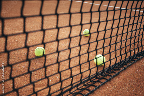 Tennis balls on clay court. © kojala