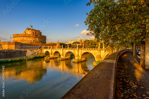 Castle Sant Angelo (Mausoleum of Hadrian), bridge Sant Angelo and river Tiber in the rays of sunset in Roma. Italy
