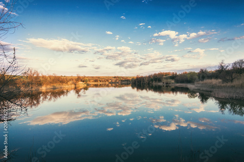 Fototapeta Naklejka Na Ścianę i Meble -  View of the lake in the bright sky