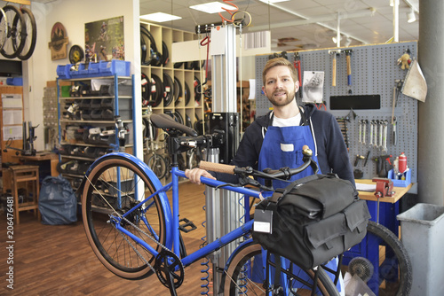 Bicycle mechanic in his repair shop, portrait