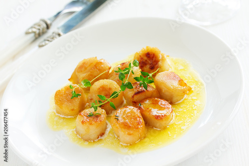 Scallops fried in cream sauce with herbs.