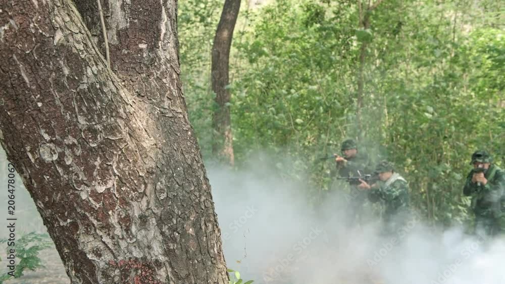 Soldiers aiming their assault rifles in jungle. Chinese soldiers in ...