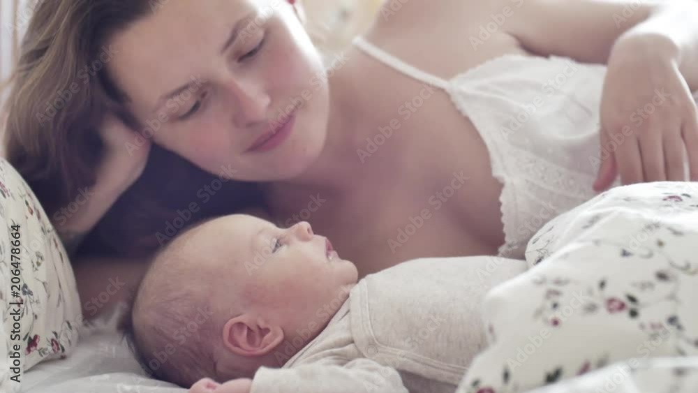 beautiful young mother smile and look at her newborn child beautiful young mother smile and look at her newborn child