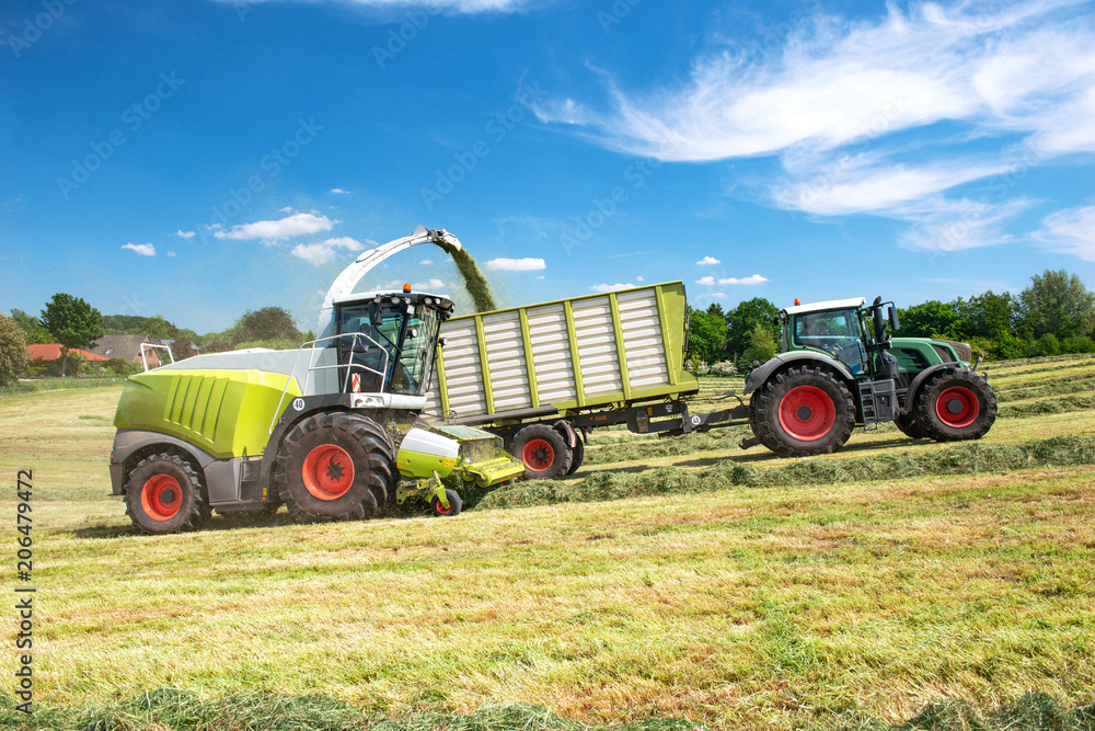 Obraz premium Farm machinery harvesting hay in a meadow - 8973