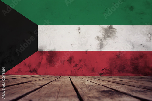 The floor of planks and plastered wall with a painted Kuwait flag.