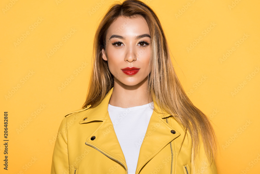 portrait of young stylish asian woman isolated on yellow background portrait of young stylish asian woman isolated on yellow background