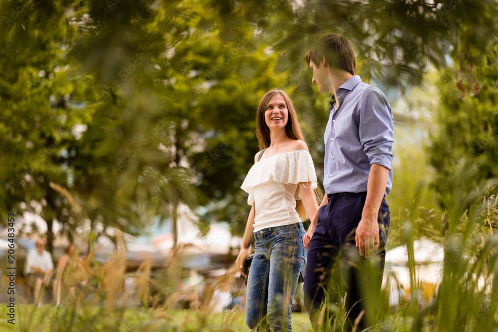 Love couple walking in park, holding hands. Love couple walking in park, holding hands.