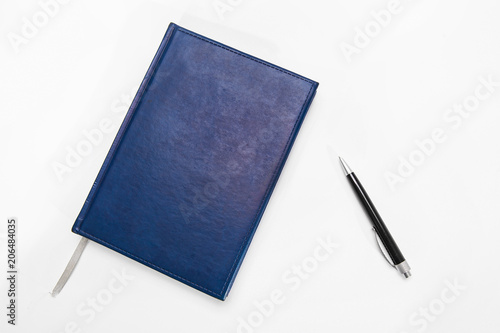 Blue notebook and pen for doing business