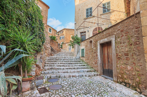 Stone street and houses in Fornalutx town. Old charming mediterranean village in Majorca island.