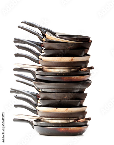 Stack  of used frying pans isolated on white