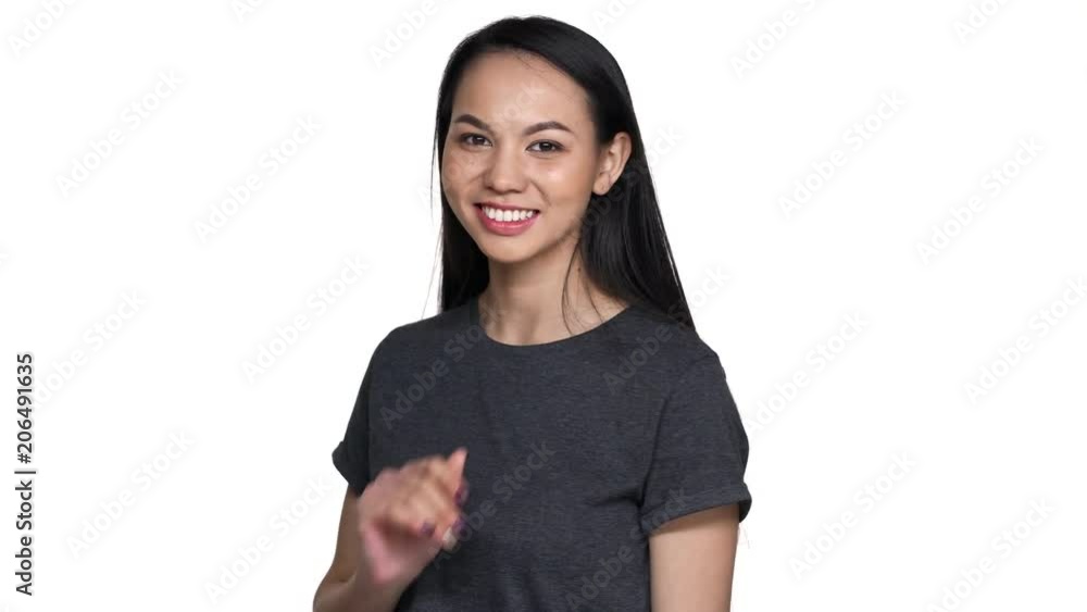 Portrait of playful flirting asian woman 20s in casual t-shirt with long hair showing her romantic feelings and blowing air kiss to you, isolated over white background. Concept of emotions Portrait of playful flirting asian woman 20s in casual t-shirt with long hair showing her romantic feelings and blowing air kiss to you, isolated over white background. Concept of emotions