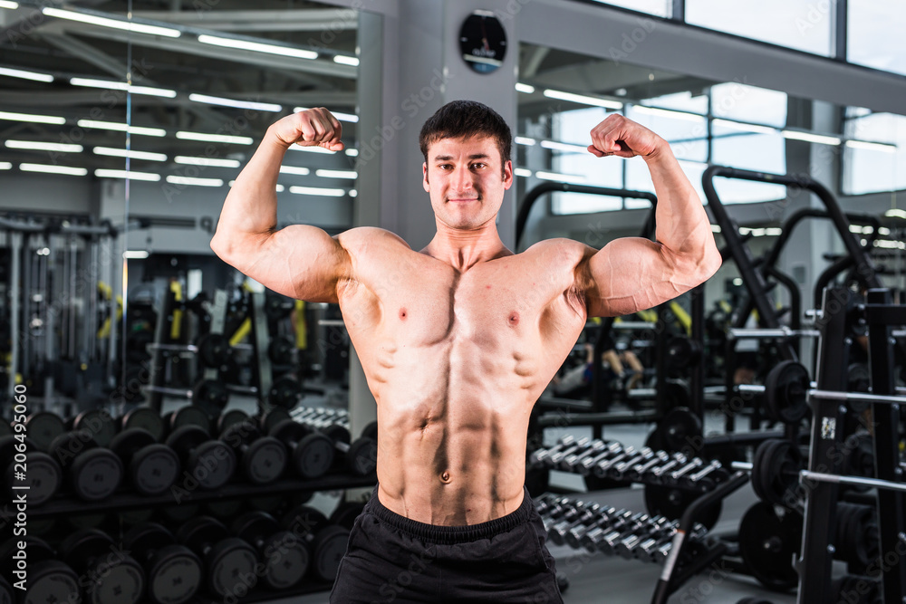 Handsome bodybuilder man with big muscles in the gym Handsome bodybuilder man with big muscles in the gym