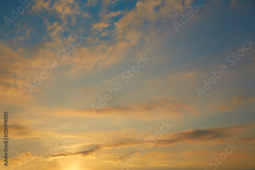 Sunset sky orange clouds on blue sky © lunamarina