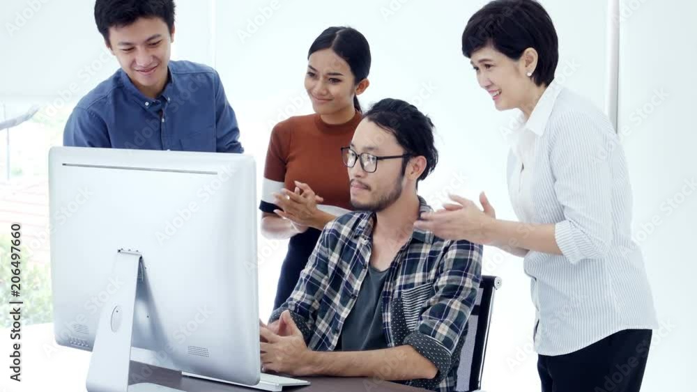 Asian people working together at office. Man show project business on monitor with team. Asian people working together at office. Man show project business on monitor with team.