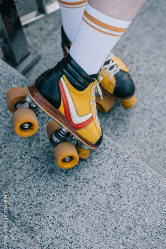 close-up partial girl on girl wearing roller skates on stairs