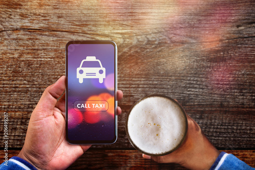 Call Taxi Application Concept. Drunker Man using Smartphone to Calling Cab in Pub or Restaurant photo