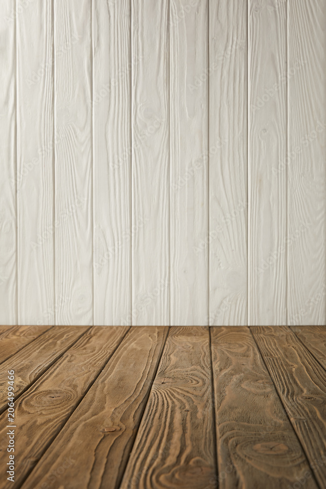 Naklejka premium brown striped tabletop and white wooden wall